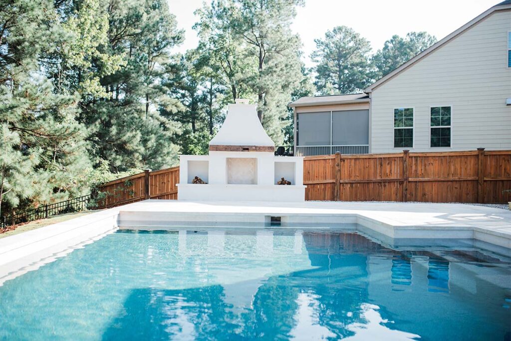 Front view of fireplace of Contemporary Durham, with concrete pool in front