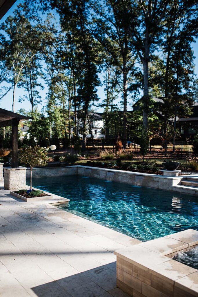 Wide view of Contemporary Raleigh project with retaining wall and pool surrounds