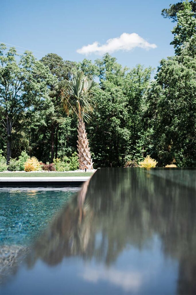 Close up Modern Apex spa, with it out of focus and pool in the background in focus