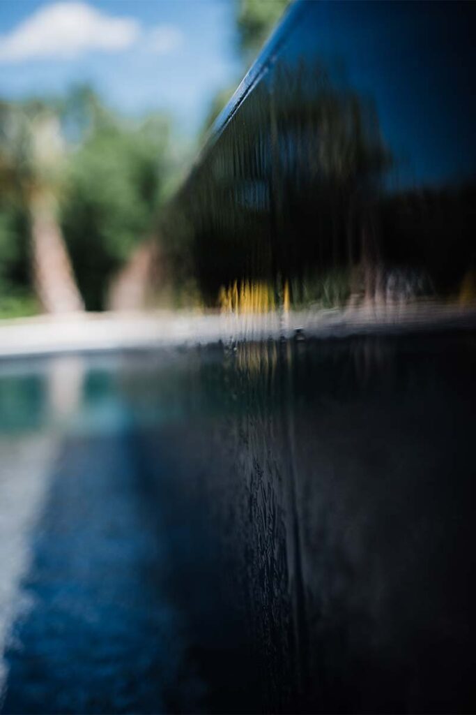 Extreme close up of Modern Apex inset spa display color and water spilling